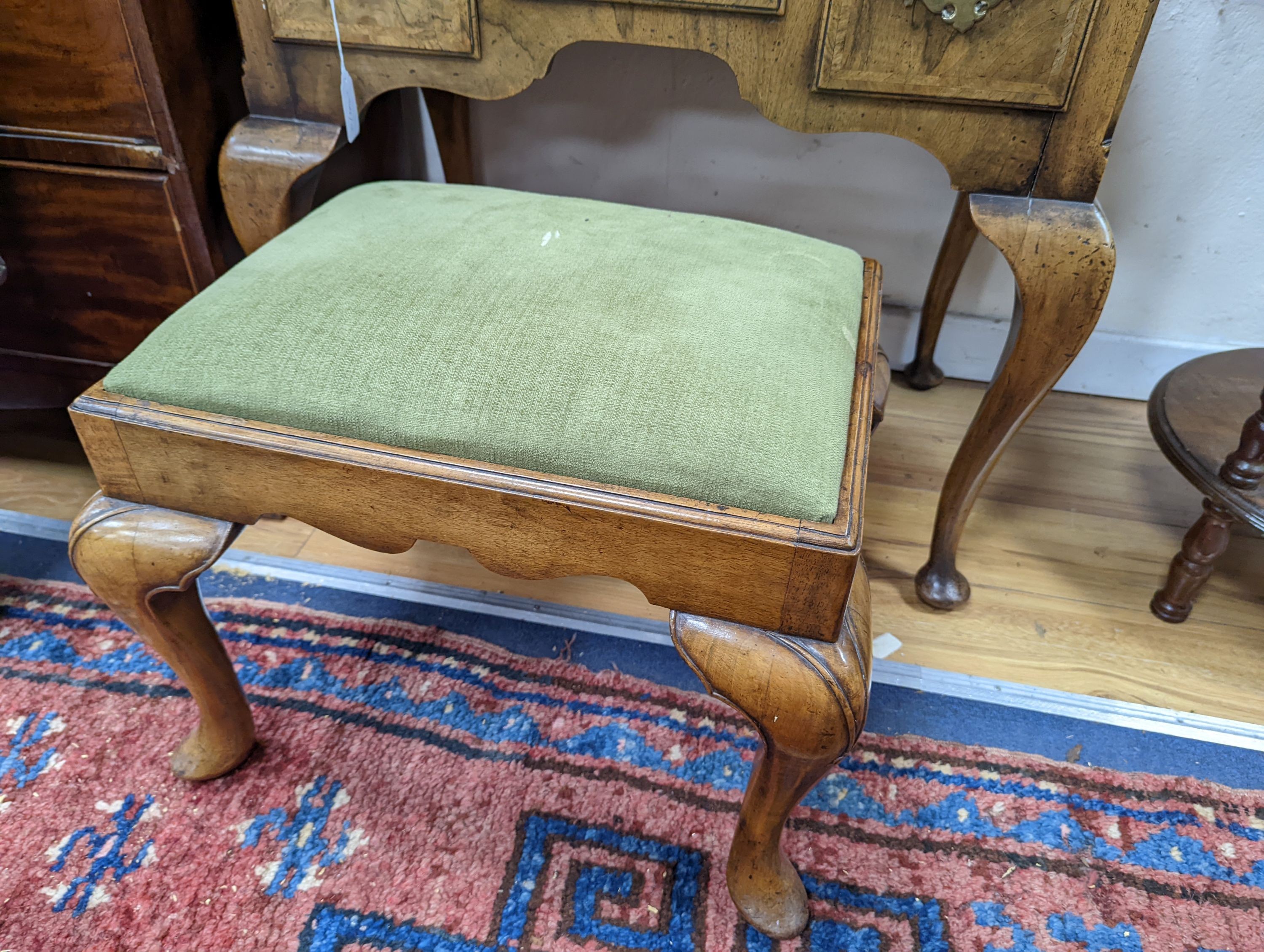 A 1920's Queen Anne revival banded walnut lowboy, width 76cm, depth 51cm, height 75cm together with a similar rectangular walnut dressing stool